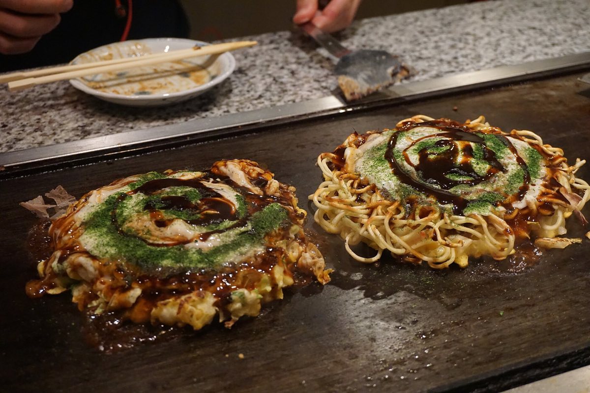 Okonomiyaki cooking on a teppan in Osaka